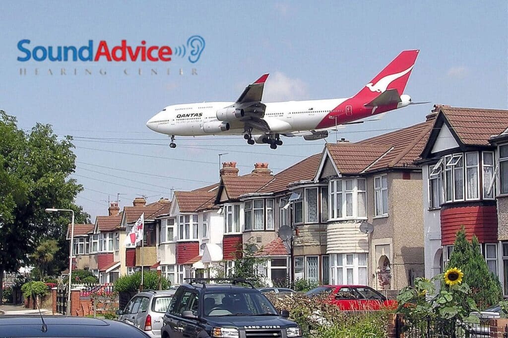 plane flying low over a neighborhood