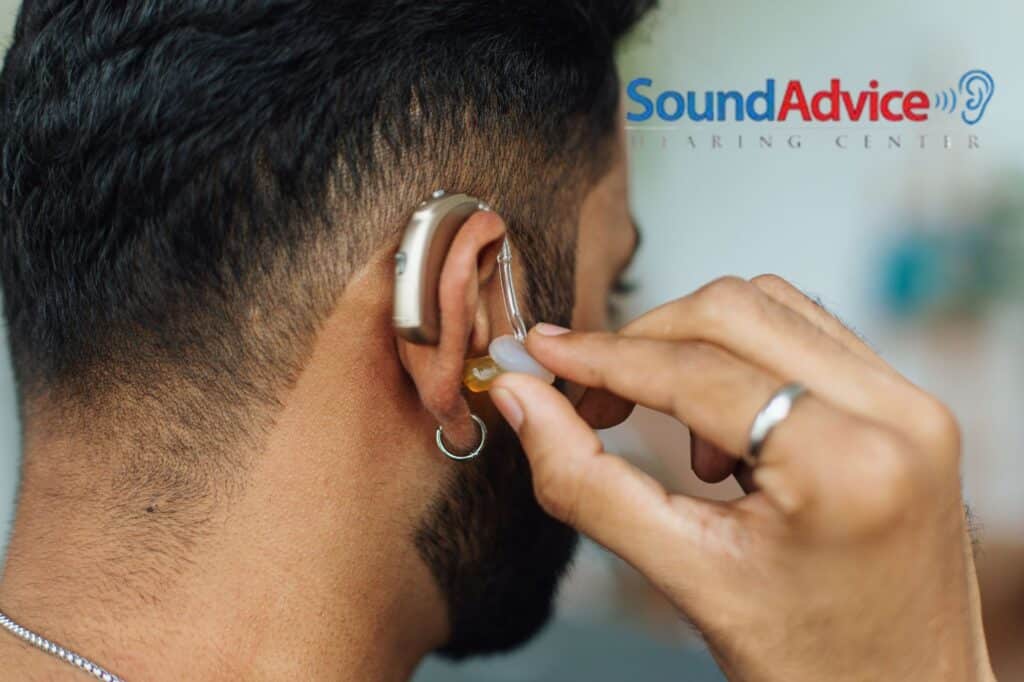 man putting in his hearing aid