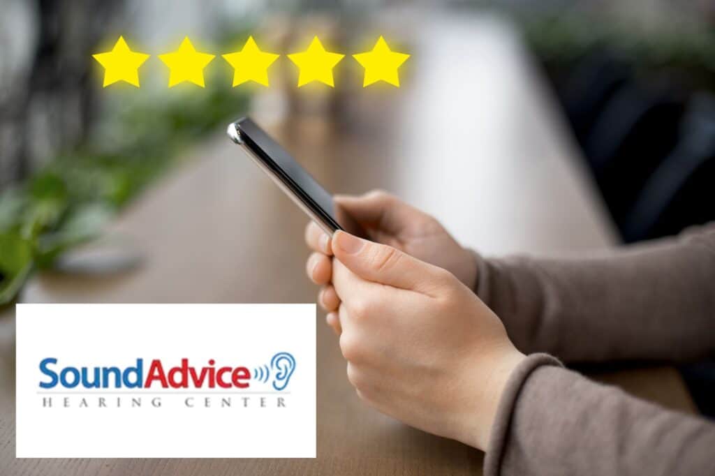 hands holding a phone with five golden stars above it